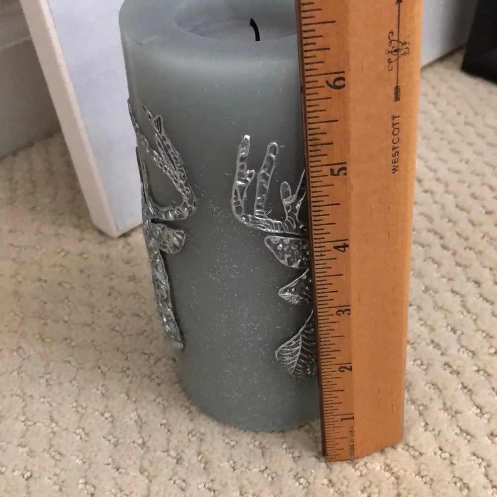Pier 1 candle deer motif. Unused. Grey, blue, silver. 3” wide, 6” high